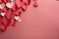 A vibrant assortment of paper hearts in various sizes, colors, and patterns neatly laid out on a gentle pink backdrop