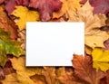 Vibrant Autumn Leaves Frame a Blank White Card on Wood Surface in Flat Lay Royalty Free Stock Photo