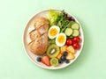 Healthy Breakfast Plate with Whole Grain Bread, Boiled Egg, Fresh Salad, and Assorted Fruits Royalty Free Stock Photo