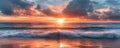 beach sunset with dramatic colors and soft waves reflecting the last light of day Royalty Free Stock Photo