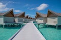 Vibrant beautiful beach landscape of the over water bungalows at luxury tropical resort in Maldives