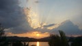 Vibrant beauty from sunset River. Dramatic clouds during sunset with clouds light rays over the mountains and river Royalty Free Stock Photo