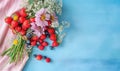 Vibrant berries and flowers against a blue backdrop. Created by AI