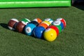 Vibrant billiards soccer/footballs balls on the green grass cued up for children`s recreation and fun outdoors Royalty Free Stock Photo