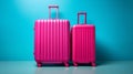 Vibrant blue backdrop with two bright pink suitcases travel luggage set for vacation