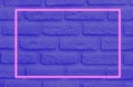 Vibrant blue brick wall layout and pink neon glowing frame. Vaporwave retro pattern for design Royalty Free Stock Photo