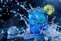 Vibrant Blue Cocktail Splash with Citrus Garnish in Bar Setting Royalty Free Stock Photo