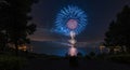 Spectacular Blue Fireworks Display Over Calm Lake at Night Royalty Free Stock Photo