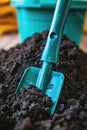 A vibrant blue garden shovel in soil, indicating activity in planting or gardening. Royalty Free Stock Photo