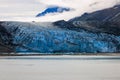 Vibrant blue glacier melting into a body of water: Glacier Bay National Park Royalty Free Stock Photo