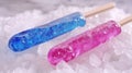 Blue and Pink Fruit Popsicles on Crushed Ice in Studio Lighting Royalty Free Stock Photo