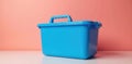 A vibrant blue plastic container with a sturdy handle, ideal for storage or organization, sits on a clean white surface against a Royalty Free Stock Photo