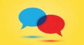 Vibrant blue and red speech bubbles over yellow background concept Royalty Free Stock Photo