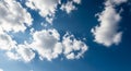 Bright Blue Sky with Fluffy White Cumulus Clouds and Sun Rays image photo Royalty Free Stock Photo