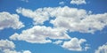 Vibrant blue sky with illuminated puffy clouds