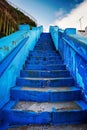 Vibrant blue staircase against a clear sky Royalty Free Stock Photo