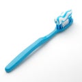 A blue toothbrush with a wavy stripe of white and blue toothpaste on a white background Royalty Free Stock Photo