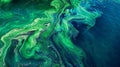 A vibrant bluegreen algal bloom forming distinct patterns and swirls as it consumes nutrients and spreads rapidly in a