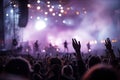Concert Crowd with Raised Hands and Stage Lights Royalty Free Stock Photo