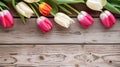 A vibrant bouquet of bright tulips on a rustic wooden table celebrates the beauty and love of spring