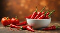 A vibrant bowl of bright red chili peppers, a culinary delight, sits on a rustic surface, surrounded by additional peppers, Royalty Free Stock Photo
