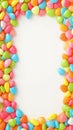 Vibrant candy frame Close up of rainbow colored dragee on white