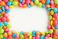 Vibrant candy frame Close up of rainbow colored dragee on white