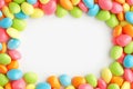 Vibrant candy frame Close up of rainbow colored dragee on white