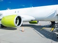 Vibrant cargo plane parked on a European tarmac, its prominent engine and striking lime accents highlighting the robust logistics Royalty Free Stock Photo