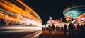 Vibrant carnival night scene with colorful rides, games, food stalls, and blurred bokeh effect Royalty Free Stock Photo