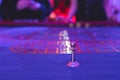 Vibrant casino table with roulette in motion, with casino chips, tokens, the hand of croupier, dollar bill money and a group of Royalty Free Stock Photo