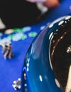 Vibrant casino table with roulette in motion, with casino chips, tokens, the hand of croupier, dollar money and a group of Royalty Free Stock Photo