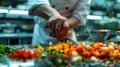 Vibrant chef in busy kitchen preparing gourmet dish with finely chopped vegetables