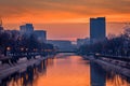 Vibrant cityscape shot early morning before sunrise in Bucharest with a river in the foreground with ducks swimming Royalty Free Stock Photo