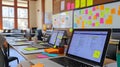 A vibrant coding bootcamp setup with laptops, whiteboards, and sticky