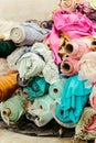 Vibrant collection of multicolored fabric rolls and swatches, arranged in a neat pile