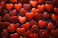 A vibrant collection of red heart-shaped objects on a dark background. Royalty Free Stock Photo