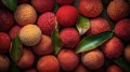 Vibrant collection of ripe lychees with green leaves.