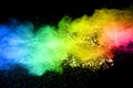 Vibrant color powder explosion cloud isolated on black background.