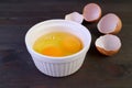 Raw eggs in a bowl with cracked eggshells in the backdrop Royalty Free Stock Photo
