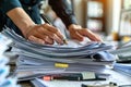 Businesswoman Signing Documents Amidst Stack of Papers Royalty Free Stock Photo