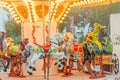 Vibrant colored carousel with lights and horses, close up, outdoor near beach, seaside