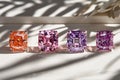 Vibrant colored gemstones shimmer under radiant sunlight against a pristine white backdrop