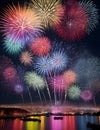 vibrant and colorful fireworks display over the city illuminating the night sky Royalty Free Stock Photo
