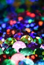 Vibrant colorful rainbow sequins close up vertical background with bokeh