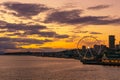 Vibrant and colorful Seattle skyline waterfont with the Great or Ferris Wheel at sunset or dusk from Elliott Bay, Washington state