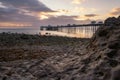 Vibrant colorful sunrise over the rugged rocky coastline with Llandudno Pier in the background - North Wales Royalty Free Stock Photo