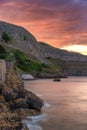 Vibrant colorful sunset over a dramatic rugged coastline surrounded by cliffs. North Wales Royalty Free Stock Photo