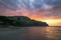 Vibrant colorful sunset over a dramatic rugged coastline surrounded by cliffs. North Wales Royalty Free Stock Photo