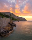 Vibrant colorful sunset over a dramatic rugged coastline surrounded by cliffs. Llandudno North Wales Royalty Free Stock Photo